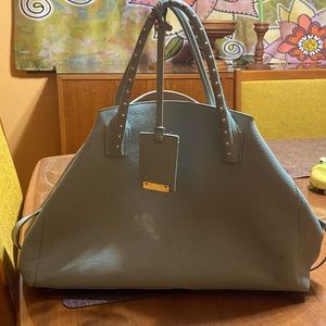 La Ccci handbag. Like new. Barely used in baby blue leather with tan interior.